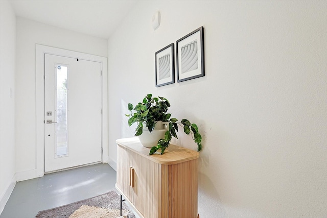 foyer entrance featuring concrete flooring