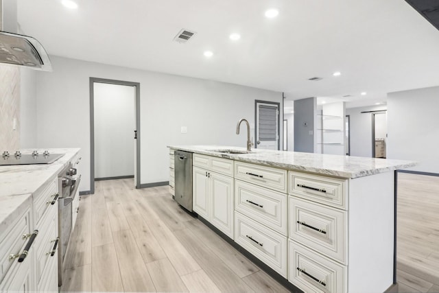 kitchen featuring sink, dishwasher, an island with sink, light stone countertops, and exhaust hood