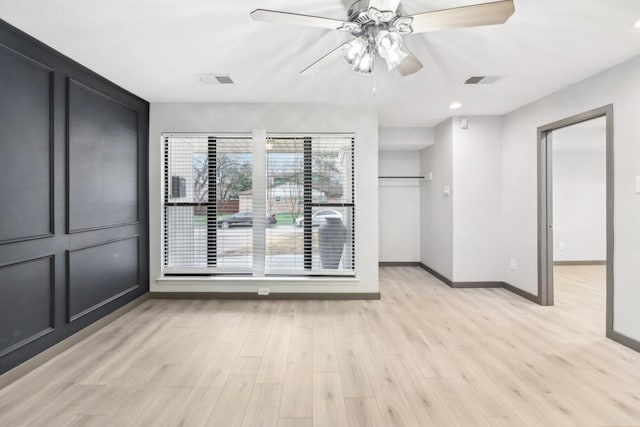 unfurnished room featuring ceiling fan and light hardwood / wood-style flooring