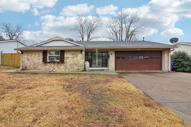 single story home featuring a garage and a front lawn