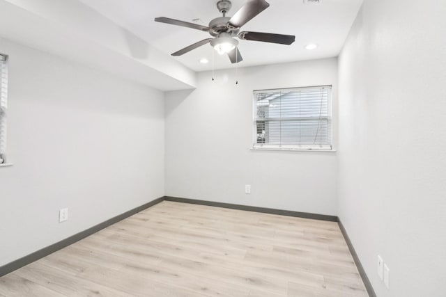 spare room with ceiling fan and light wood-type flooring