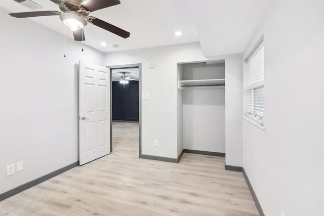 unfurnished bedroom with light hardwood / wood-style floors, a closet, and ceiling fan