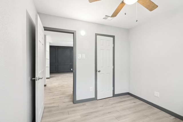 unfurnished bedroom featuring ceiling fan and light wood-type flooring