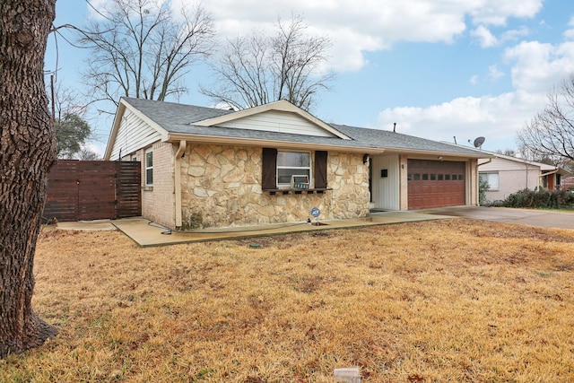 single story home featuring cooling unit, a garage, and a front lawn