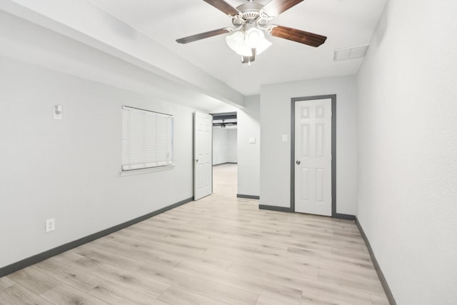 spare room featuring ceiling fan, vaulted ceiling, and light wood-type flooring