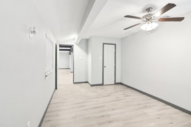 interior space featuring lofted ceiling with beams, ceiling fan, and light hardwood / wood-style floors