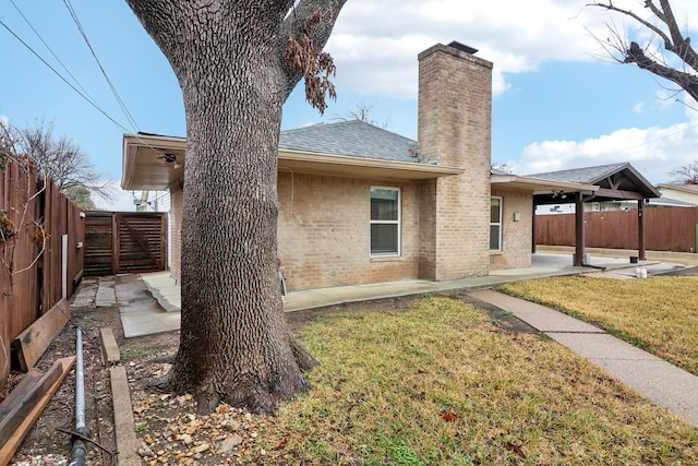 rear view of house featuring a patio and a yard