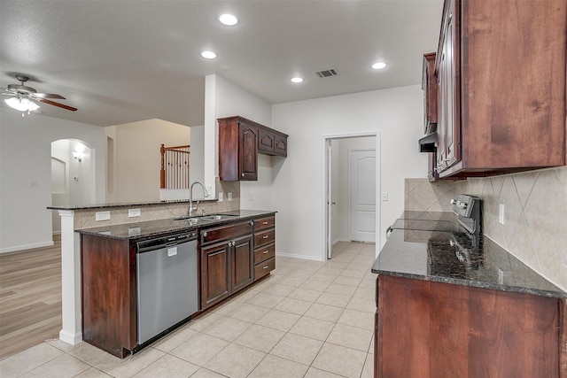 408 Elk Run Dr, Fort Worth, TX 76140 - kitchen featuring dishwasher, sink, dark stone counters, stove, and ceiling fan