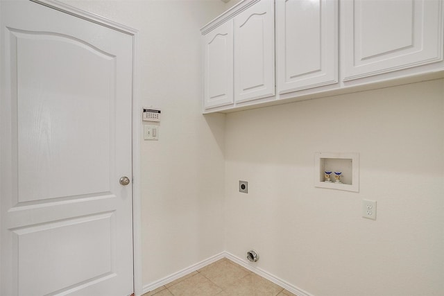 408 Elk Run Dr, Fort Worth, TX 76140 - clothes washing area with electric dryer hookup, washer hookup, light tile patterned floors, and cabinets