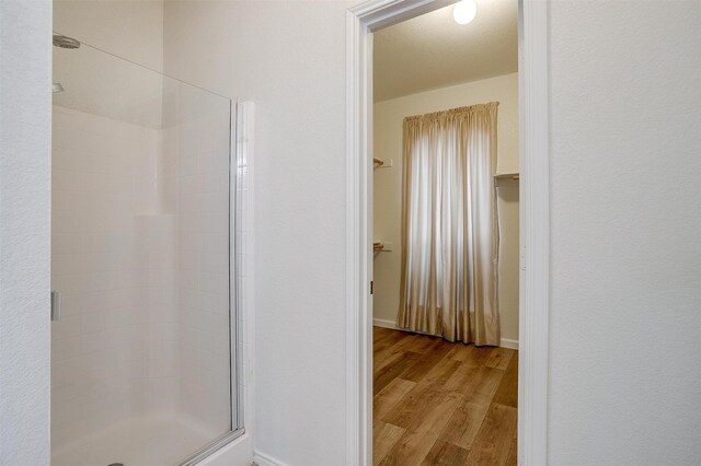 408 Elk Run Dr, Fort Worth, TX 76140 - bathroom featuring wood-type flooring and a shower with shower door