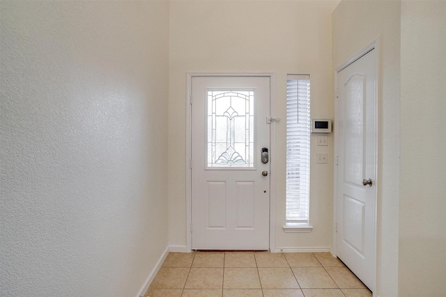 foyer with light tile patterned flooring and plenty of natural light