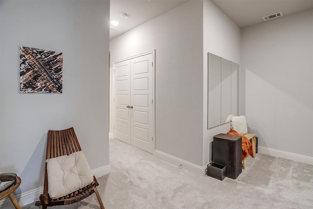 living area with light colored carpet