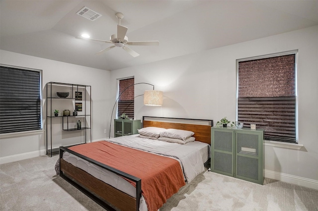 bedroom featuring light carpet, lofted ceiling, and ceiling fan