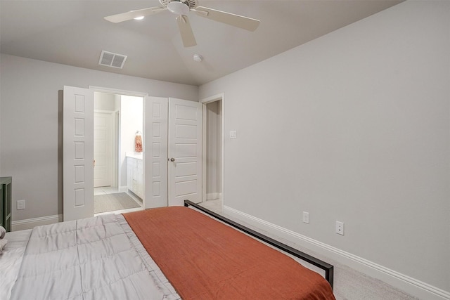 bedroom with ceiling fan, lofted ceiling, carpet floors, and ensuite bath