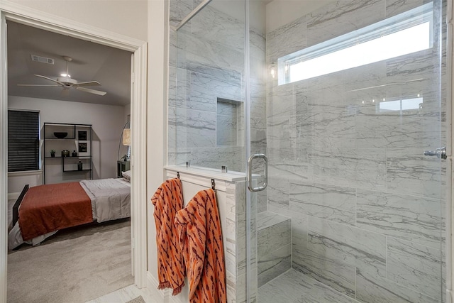 bathroom featuring a shower with door and ceiling fan