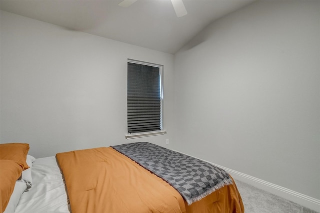 bedroom with vaulted ceiling, ceiling fan, and carpet floors