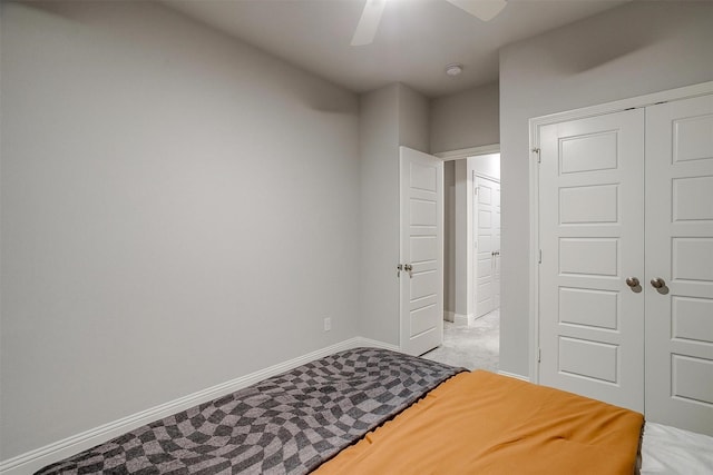 bedroom with carpet flooring, ceiling fan, and a closet