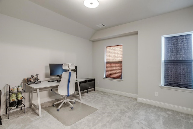 carpeted office space featuring lofted ceiling