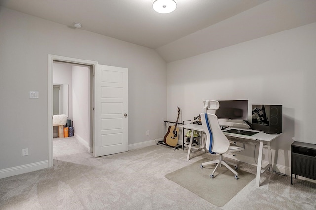 office space featuring vaulted ceiling and light carpet