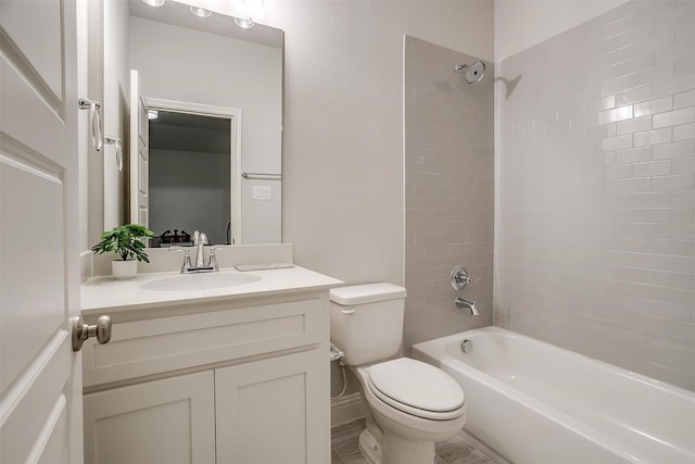 full bathroom featuring vanity, toilet, and tiled shower / bath combo