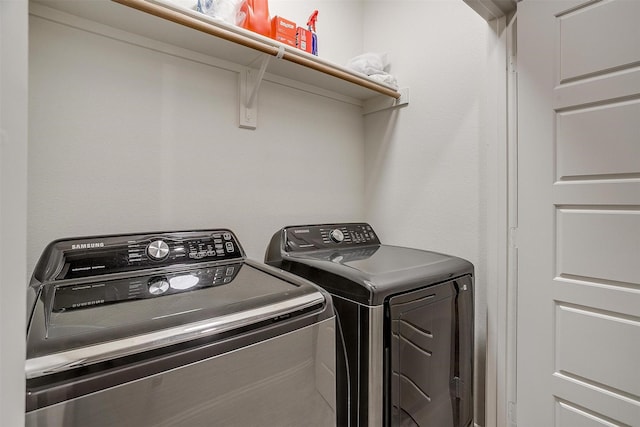 clothes washing area featuring washer and dryer