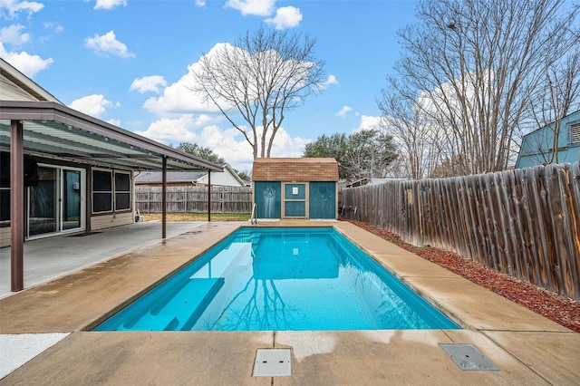 view of pool featuring a patio, a fenced backyard, a storage shed, an outdoor structure, and a fenced in pool