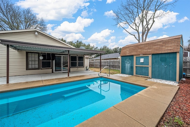 view of swimming pool featuring an outbuilding, a patio, a fenced backyard, a shed, and a fenced in pool