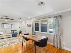 dining space featuring hardwood / wood-style flooring, ceiling fan, and crown molding