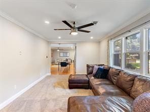 living room with crown molding and ceiling fan