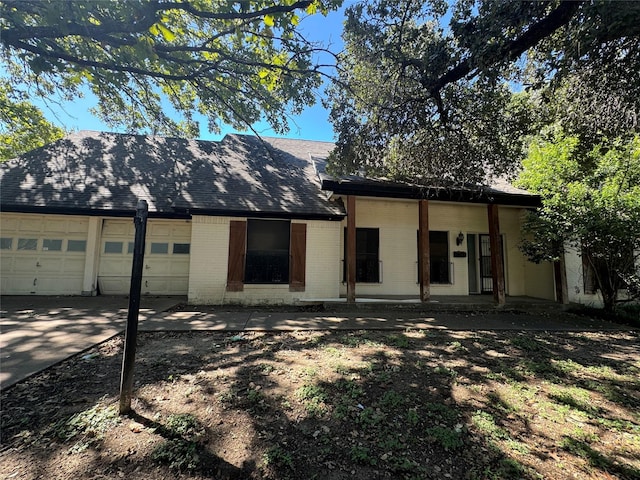 rear view of house featuring a garage