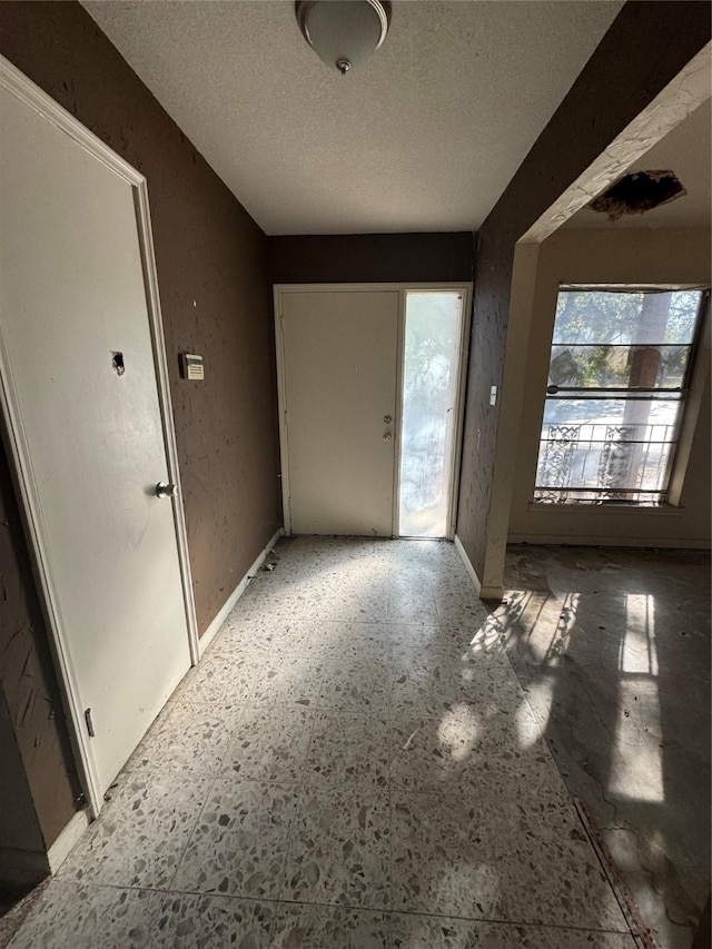 foyer with a textured ceiling