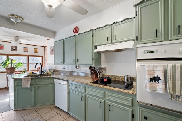 kitchen with white appliances, a textured ceiling, light stone countertops, ceiling fan, and kitchen peninsula