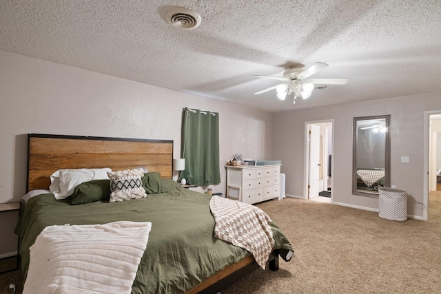 carpeted bedroom with ceiling fan and a textured ceiling