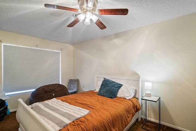 carpeted bedroom featuring a textured ceiling and ceiling fan