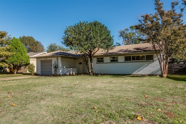 single story home with a garage and a front lawn