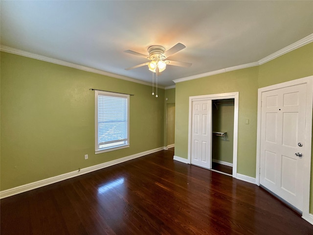 unfurnished bedroom with crown molding, ceiling fan, dark hardwood / wood-style flooring, and a closet