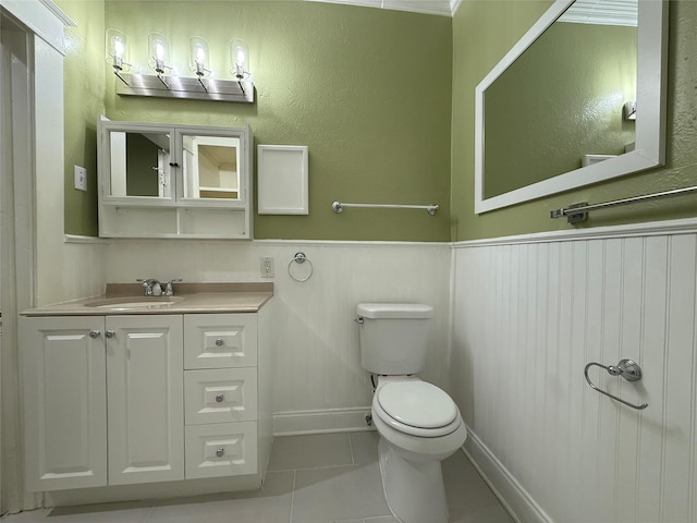 bathroom featuring vanity, tile patterned floors, and toilet