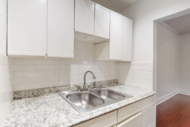 kitchen featuring white cabinetry, sink, dark hardwood / wood-style flooring, and tasteful backsplash