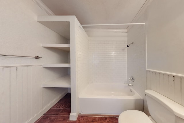 bathroom featuring crown molding, tiled shower / bath combo, and toilet