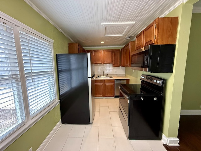 kitchen with sink, backsplash, light tile patterned floors, stainless steel appliances, and crown molding