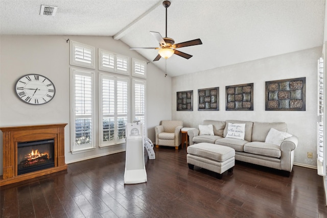 living room with dark hardwood / wood-style flooring, vaulted ceiling with beams, a textured ceiling, and ceiling fan