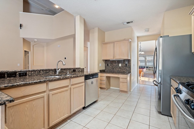 kitchen with light brown cabinetry, tasteful backsplash, sink, light tile patterned floors, and stainless steel appliances