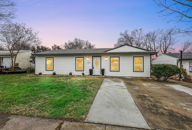 ranch-style home featuring a yard