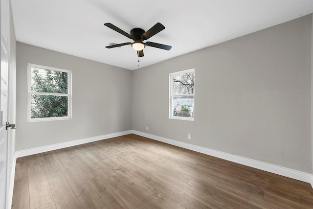 spare room with hardwood / wood-style flooring and ceiling fan