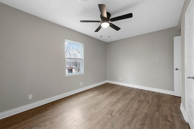 spare room featuring hardwood / wood-style floors and ceiling fan