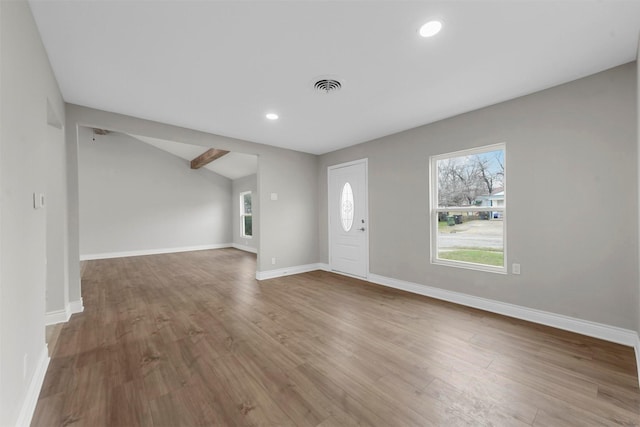 foyer entrance with vaulted ceiling and hardwood / wood-style floors