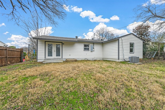 back of house featuring french doors, a lawn, and central air condition unit