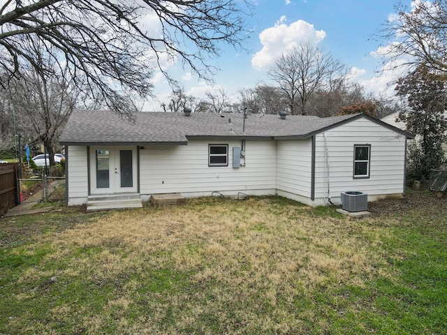 back of house with a yard and central AC unit