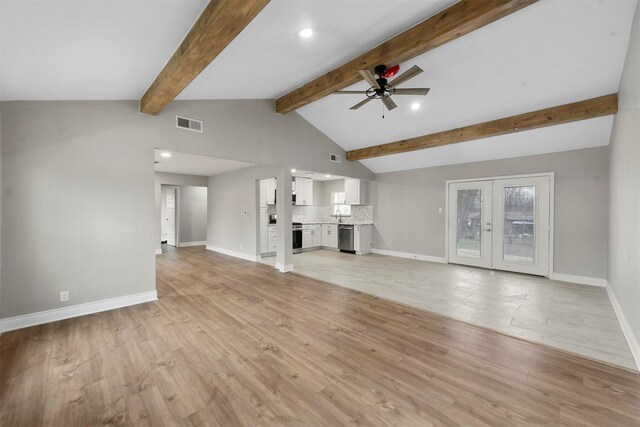 unfurnished living room featuring vaulted ceiling with beams, light hardwood / wood-style flooring, ceiling fan, and french doors
