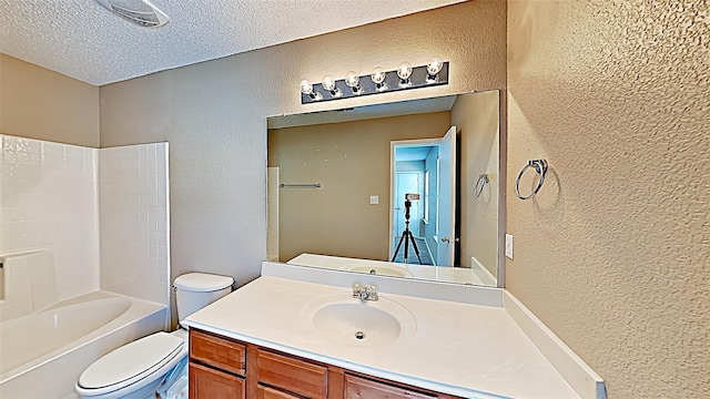 full bathroom with vanity, shower / bathing tub combination, toilet, and a textured ceiling